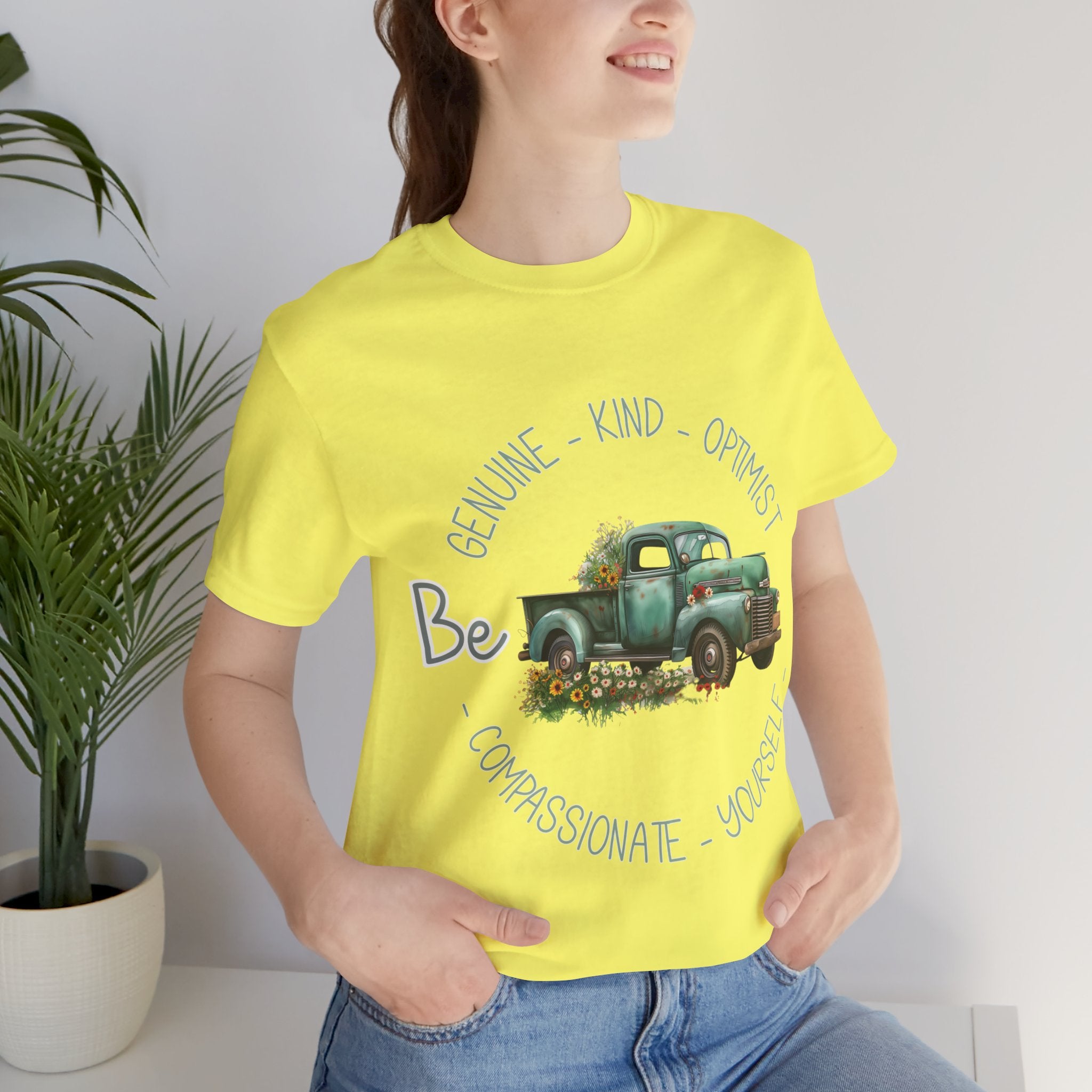 "Vintage green truck with floral decoration and inspirational words - featuring a classic old truck adorned with vibrant flowers on the sides, surrounded by the words 'Be genuine, bold, optimist, compassionate, kind, yourself', set in a beautiful context that promotes positivity and authenticity, color Aqua Athletic Heather Black Dark Grey Heather Heather Kelly Heather Navy Heather Red Heather True Royal Kelly Pink White Yellow Heather Aqua Heather Ice Blue Heather Mauve Charity Pink"