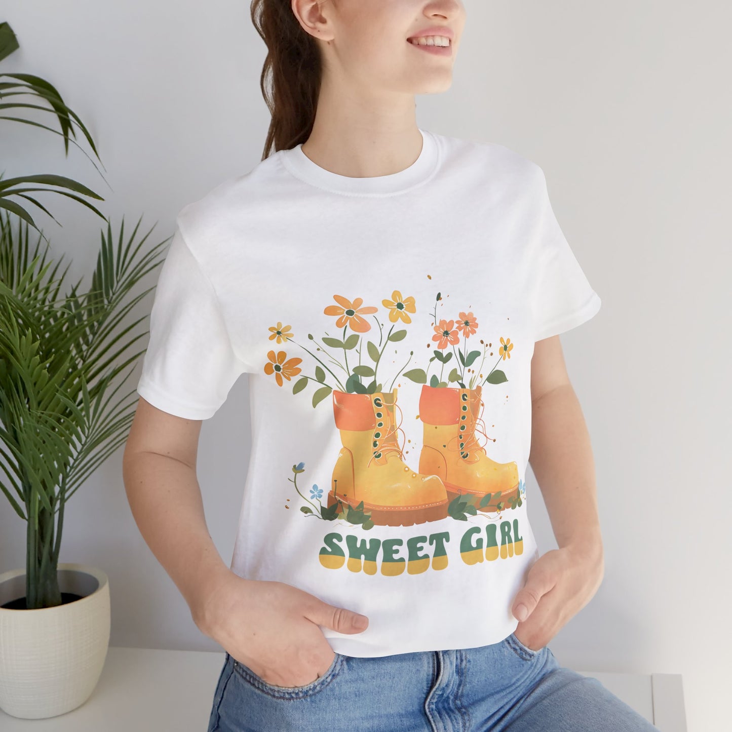 “Chic boho-style boots adorned with floral accents and ‘Sweet Girl’ text, featured on Bella Canvas 3001 t-shirts in a variety of hues Athletic Heather Berry Black Dark Grey Heather Heather Team Purple Navy White Heather Aqua Charity Pink.”