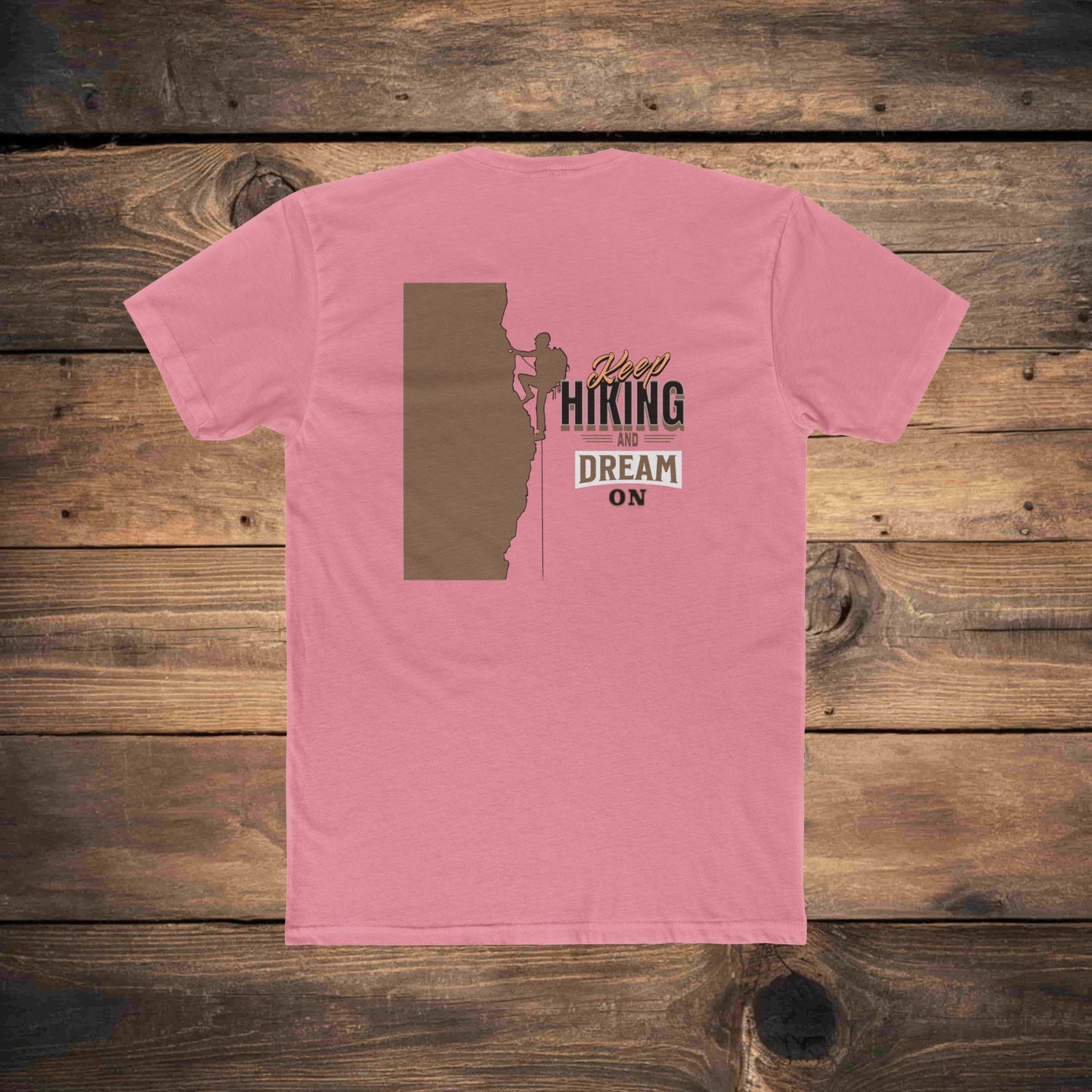 Graphic t-shirt featuring a climber on a mountain wall with motivational text 'Keep Hiking and Dream On,' crafted in breathable cotton."