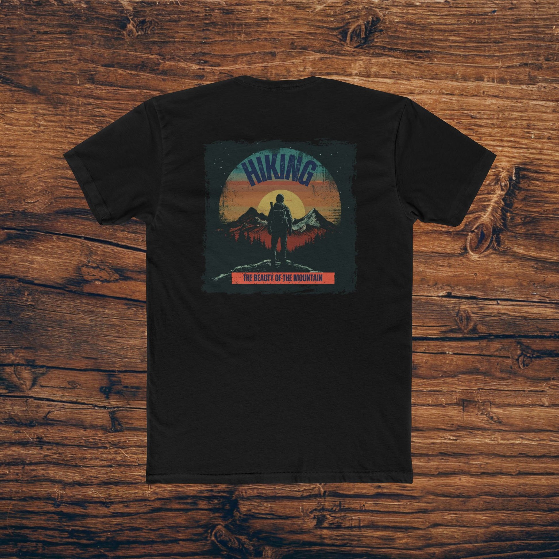 Graphic t-shirt featuring a hiker overlooking a mountain range during sunset, perfect for casual wear in soft, breathable cotton.