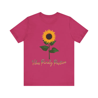 Sunflower illustration with 'Vibes Purely Positive' phrase - a vibrant sunflower with yellow petals and dark brown center, green leaves on a stem, conveying a positive message printed in t-shirts of different colors like "Army Athletic Heather Berry Black Heather Navy Heather Team Purple Navy White Ash Heather Aqua"