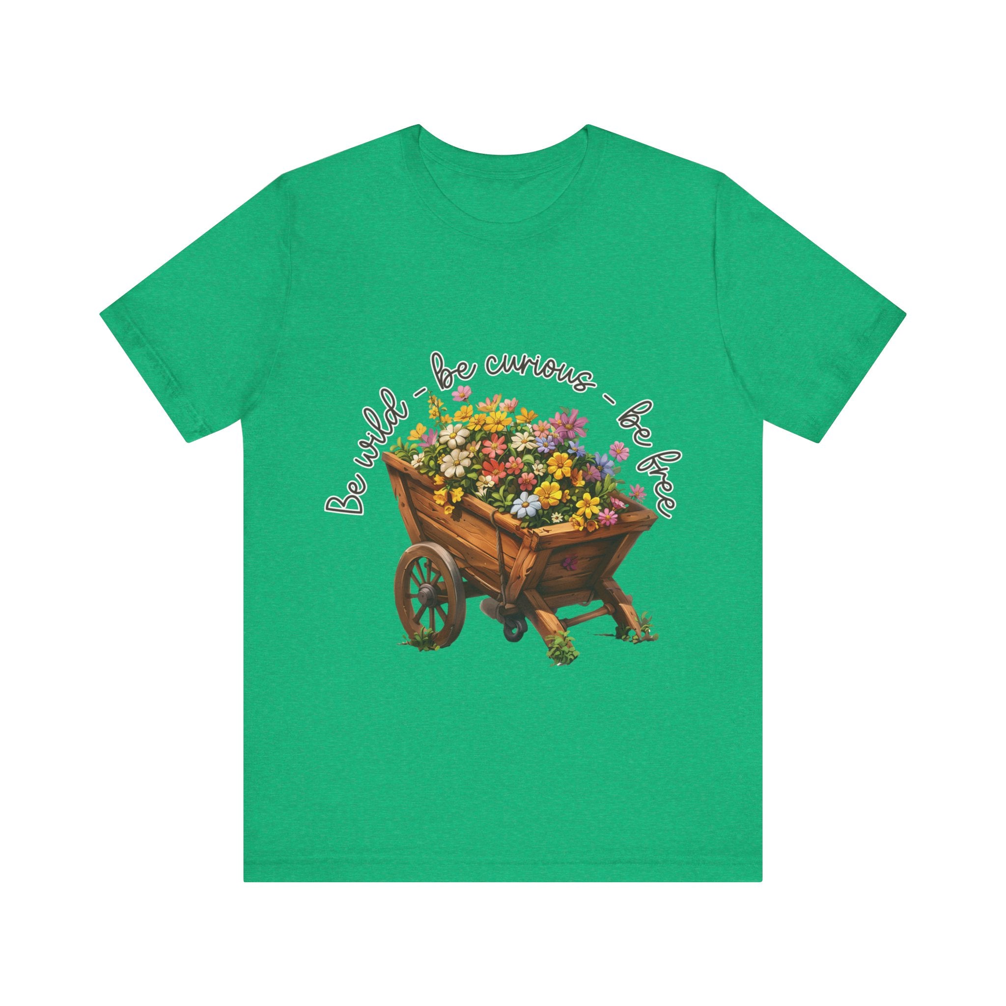 Colorful illustration of a wooden wheelbarrow filled with vibrant flowers, surrounded by the handwritten text 'Be wild - be curious - be free.' This design is intended for t-shirts in various colors, including Aqua, Athletic Heather, Black, Dark Grey Heather, Heather Kelly, Heather Red, Heather True Royal, Natural, Navy, Pink, White, Heather Aqua, Heather Ice Blue, Heather Mauve, and Charity Pink.