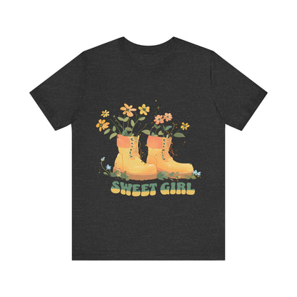 “Chic boho-style boots adorned with floral accents and ‘Sweet Girl’ text, featured on Bella Canvas 3001 t-shirts in a variety of hues Athletic Heather Berry Black Dark Grey Heather Heather Team Purple Navy White Heather Aqua Charity Pink.”