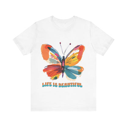 Colorful cartoon-style butterfly with vibrant wings and the text 'Life is Beautiful' designed for t-shirts in colors including Aqua, Athletic Heather, Berry, Black, Dark Grey Heather, Heather Red, Heather Team Purple, Heather True Royal, White, and Charity Pink