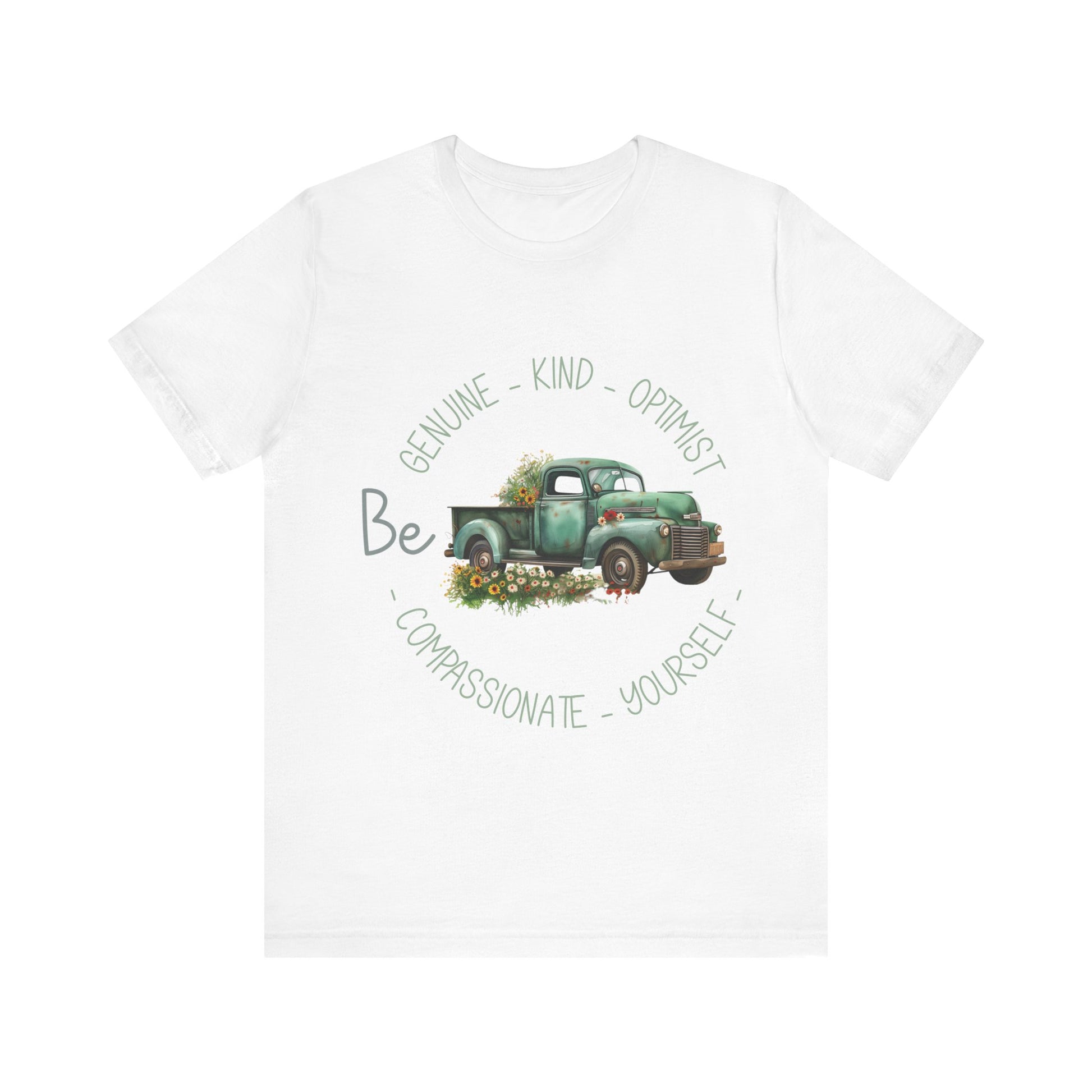 Vintage boho-style illustration of an old green truck surrounded by colorful flowers, with the text 'Be Genuine - Bold - Optimistic - Compassionate - Kind - Yourself.' This design is intended for t-shirts in various colors, including Aqua, Athletic Heather, Black, Dark Grey Heather, Heather Kelly, Heather Navy, Heather Red, Heather True Royal, Kelly, Pink, White, Yellow, Heather Aqua, Heather Ice Blue, Heather Mauve, and Charity Pink.