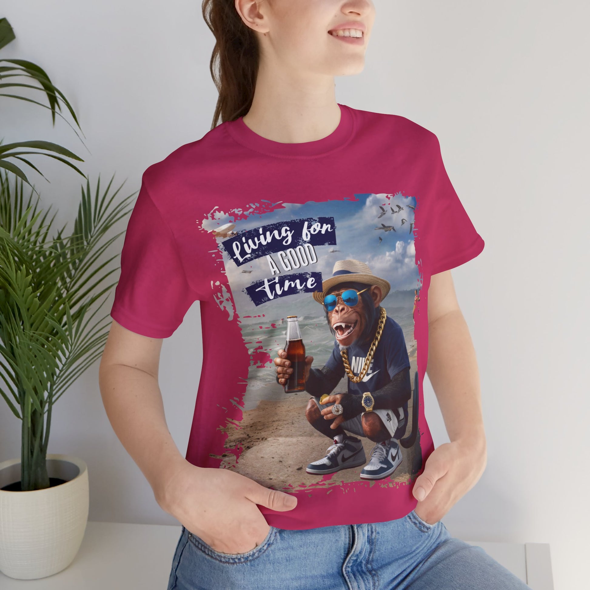 Humorous photo manipulation of a chimp on the beach dressed in hip-hop style with gold chains and sneakers, holding a bottle and money, with the slogan ‘Living for A GOOD TIME’. this image is printed in t-shirts on those colors Aqua Athletic Heather Berry Black Dark Grey Heather Kelly Heather Team Purple Heather True Royal Navy White