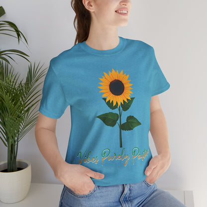 Sunflower illustration with 'Vibes Purely Positive' phrase - a vibrant sunflower with yellow petals and dark brown center, green leaves on a stem, conveying a positive message printed in t-shirts of different colors like "Army Athletic Heather Berry Black Heather Navy Heather Team Purple Navy White Ash Heather Aqua"