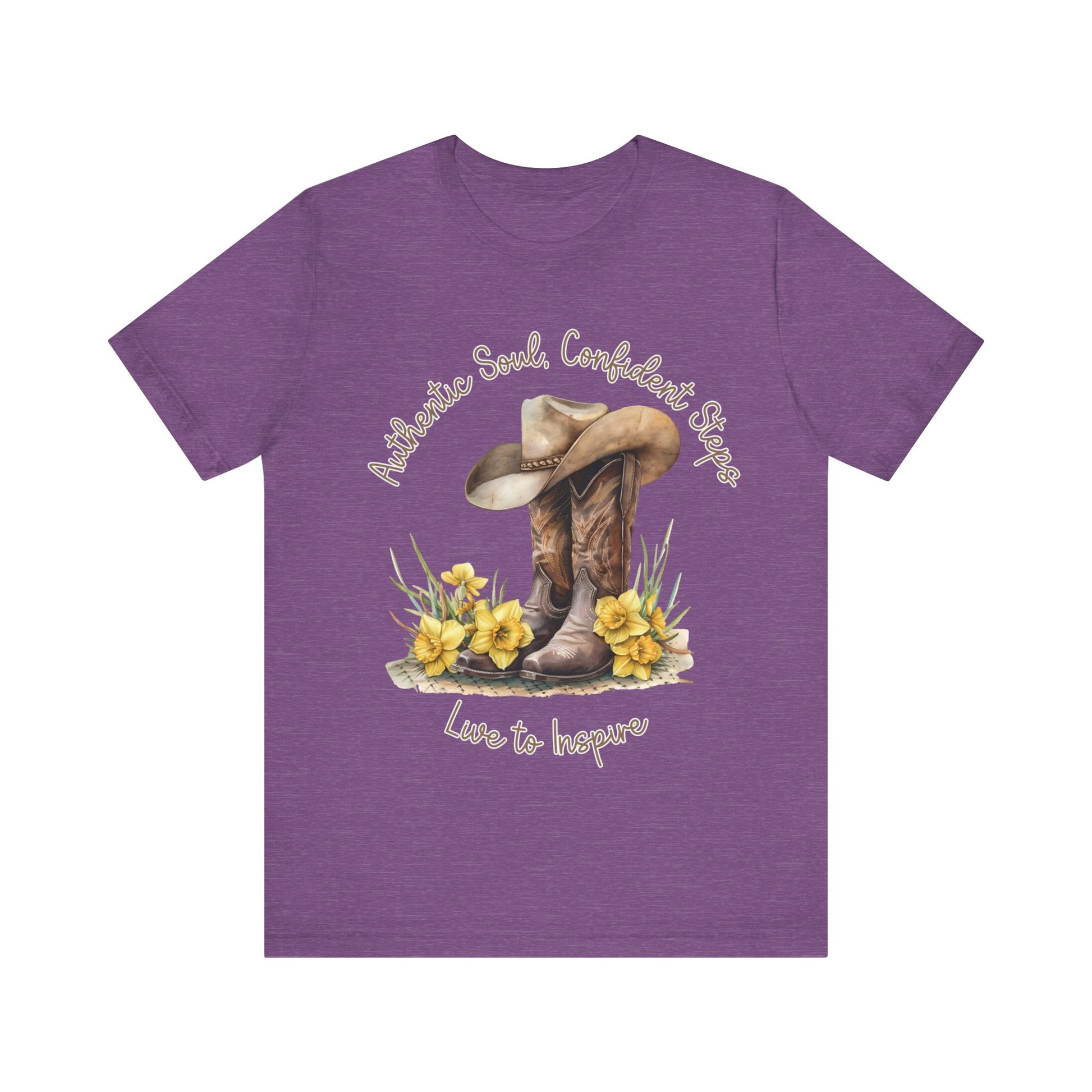 Brown leather cowboy boots with detailed stitching and a light brown hat on top, surrounded by green leaves and yellow flowers, with inspirational phrases ‘Authentic Soul,’ ‘Confident Steps,’ and ‘Live to Inspire’ written above and below on a white background colors tshirt Aqua Athletic Heather Baby Blue Black Dark Grey Heather Heather Kelly Heather Red Heather Team Purple Heather True Royal Navy Pink White Heather Aqua Heather Mauve Charity Pink.