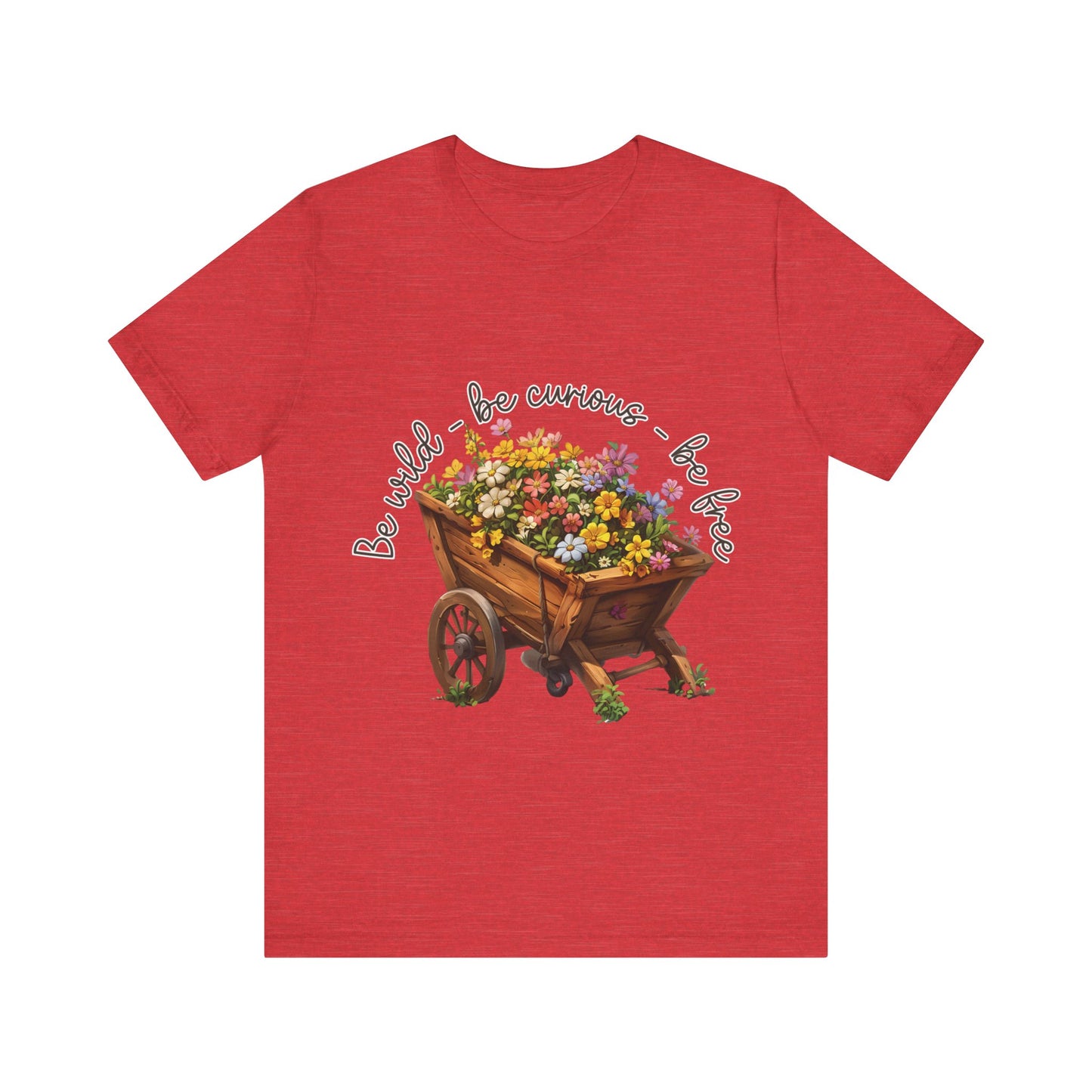 Colorful illustration of a wooden wheelbarrow filled with vibrant flowers, surrounded by the handwritten text 'Be wild - be curious - be free.' This design is intended for t-shirts in various colors, including Aqua, Athletic Heather, Black, Dark Grey Heather, Heather Kelly, Heather Red, Heather True Royal, Natural, Navy, Pink, White, Heather Aqua, Heather Ice Blue, Heather Mauve, and Charity Pink.