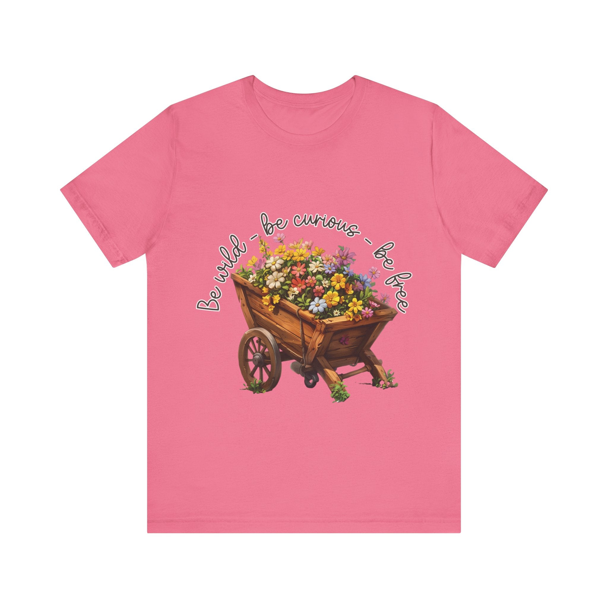 Colorful illustration of a wooden wheelbarrow filled with vibrant flowers, surrounded by the handwritten text 'Be wild - be curious - be free.' This design is intended for t-shirts in various colors, including Aqua, Athletic Heather, Black, Dark Grey Heather, Heather Kelly, Heather Red, Heather True Royal, Natural, Navy, Pink, White, Heather Aqua, Heather Ice Blue, Heather Mauve, and Charity Pink.