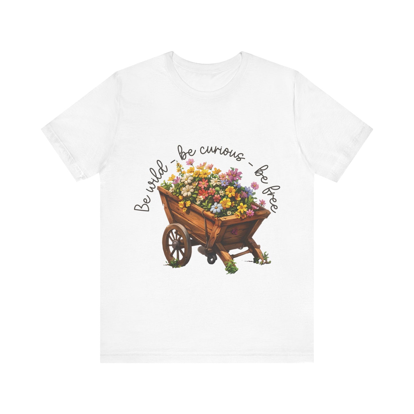 Colorful illustration of a wooden wheelbarrow filled with vibrant flowers, surrounded by the handwritten text 'Be wild - be curious - be free.' This design is intended for t-shirts in various colors, including Aqua, Athletic Heather, Black, Dark Grey Heather, Heather Kelly, Heather Red, Heather True Royal, Natural, Navy, Pink, White, Heather Aqua, Heather Ice Blue, Heather Mauve, and Charity Pink.