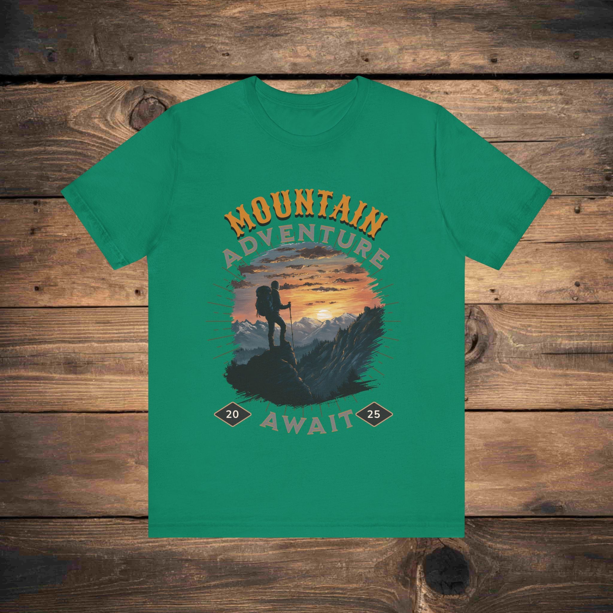 Adventure graphic tee in kelly with a detailed mountain sunset illustration, ideal for outdoor enthusiasts