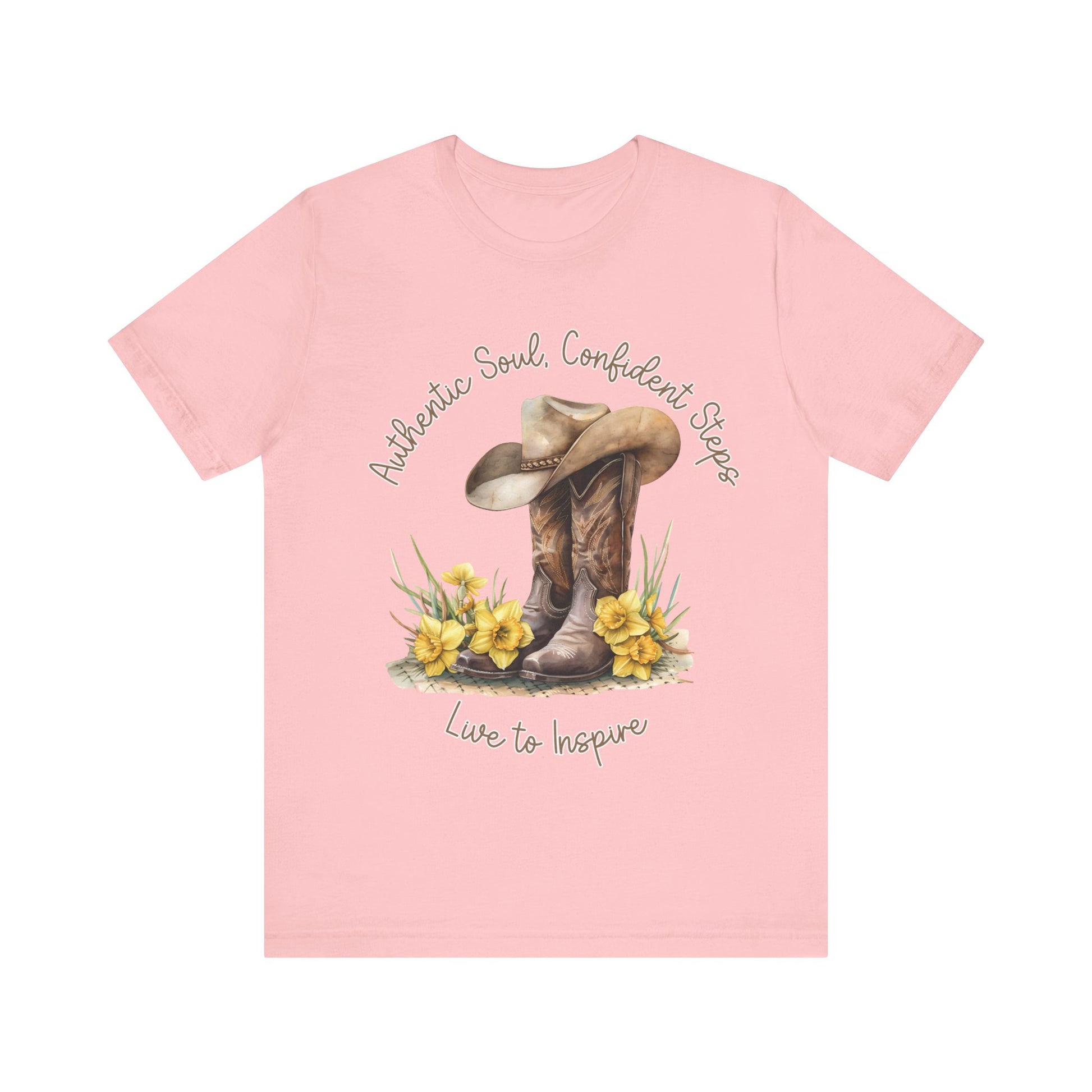 Brown leather cowboy boots with detailed stitching and a light brown hat on top, surrounded by green leaves and yellow flowers, with inspirational phrases ‘Authentic Soul,’ ‘Confident Steps,’ and ‘Live to Inspire’ written above and below on a white background colors tshirt Aqua Athletic Heather Baby Blue Black Dark Grey Heather Heather Kelly Heather Red Heather Team Purple Heather True Royal Navy Pink White Heather Aqua Heather Mauve Charity Pink.