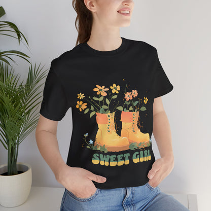 “Chic boho-style boots adorned with floral accents and ‘Sweet Girl’ text, featured on Bella Canvas 3001 t-shirts in a variety of hues Athletic Heather Berry Black Dark Grey Heather Heather Team Purple Navy White Heather Aqua Charity Pink.”