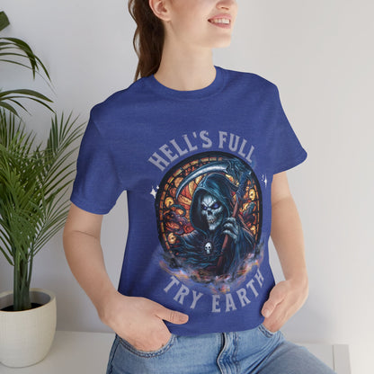 “Grim Humor: ‘Hell’s Full, Try Earth’ – A skull, adorned with the ominous aura of death, grins wickedly. Against a backdrop hinting at apocalyptic times, the text humorously suggests that even hell has reached capacity, leaving Earth as the next best option print in t-shirts in different colors like Aqua Athletic Heather Black Dark Grey Heather Heather Red Heather Team Purple Heather True Royal Kelly Navy Pink White.”