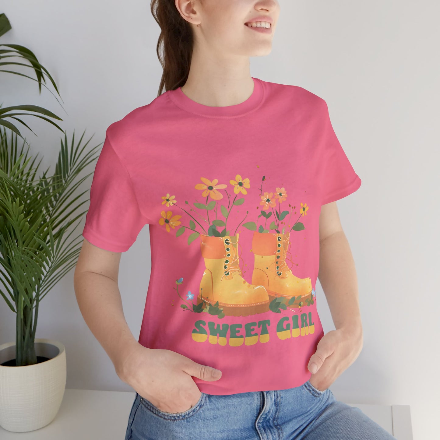 “Chic boho-style boots adorned with floral accents and ‘Sweet Girl’ text, featured on Bella Canvas 3001 t-shirts in a variety of hues Athletic Heather Berry Black Dark Grey Heather Heather Team Purple Navy White Heather Aqua Charity Pink.”