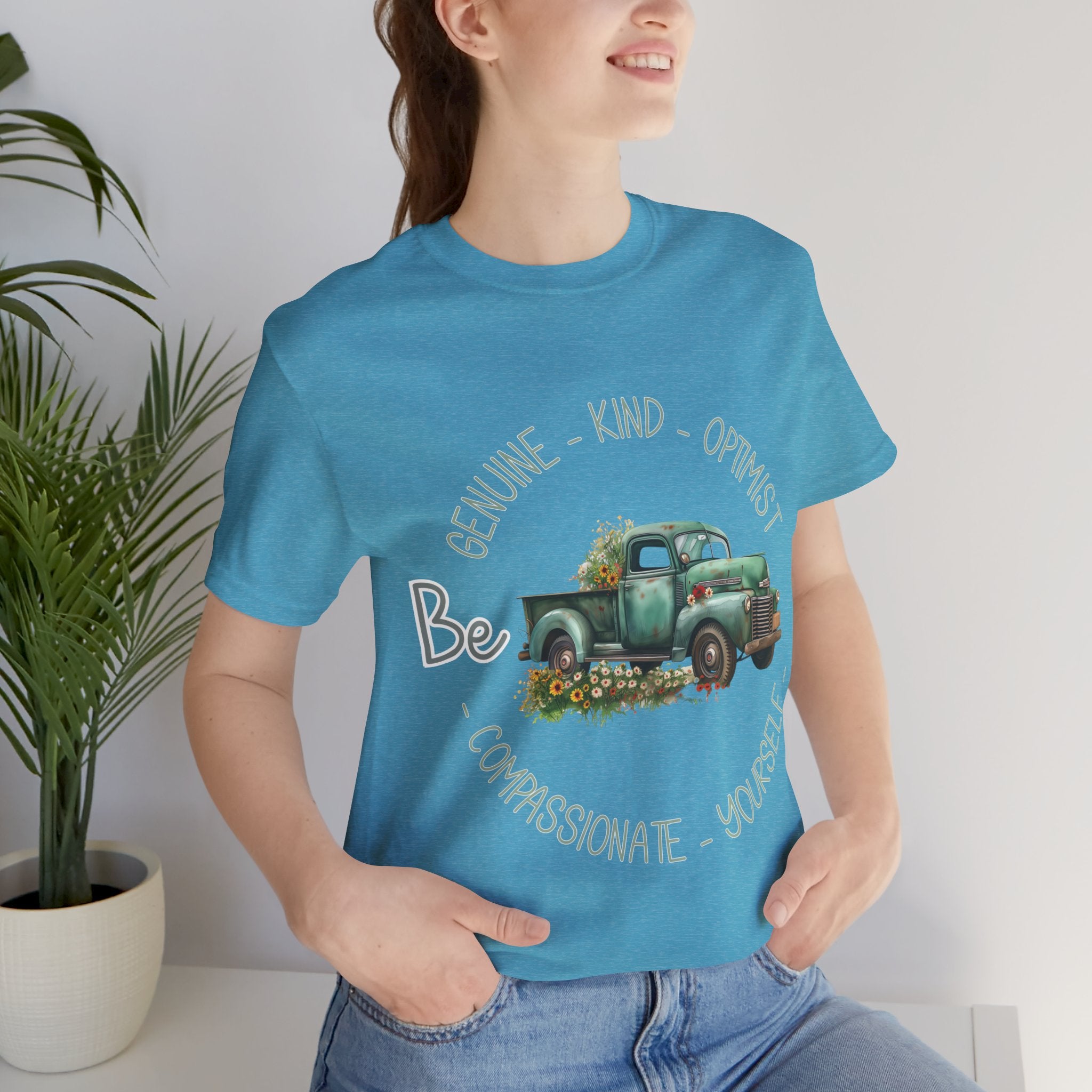 "Vintage green truck with floral decoration and inspirational words - featuring a classic old truck adorned with vibrant flowers on the sides, surrounded by the words 'Be genuine, bold, optimist, compassionate, kind, yourself', set in a beautiful context that promotes positivity and authenticity, color Aqua Athletic Heather Black Dark Grey Heather Heather Kelly Heather Navy Heather Red Heather True Royal Kelly Pink White Yellow Heather Aqua Heather Ice Blue Heather Mauve Charity Pink"