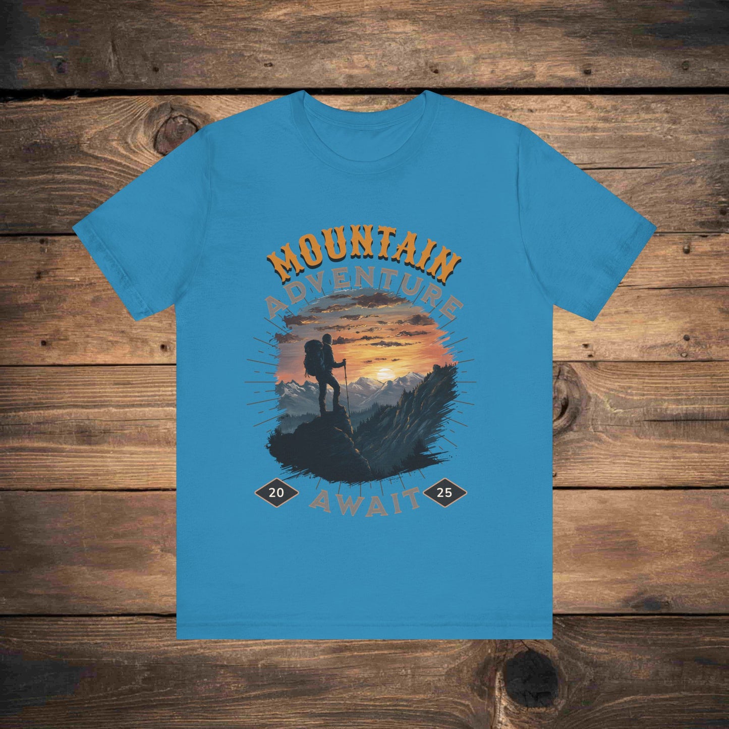 Adventure graphic tee in Blue with a detailed mountain sunset illustration, ideal for outdoor enthusiasts