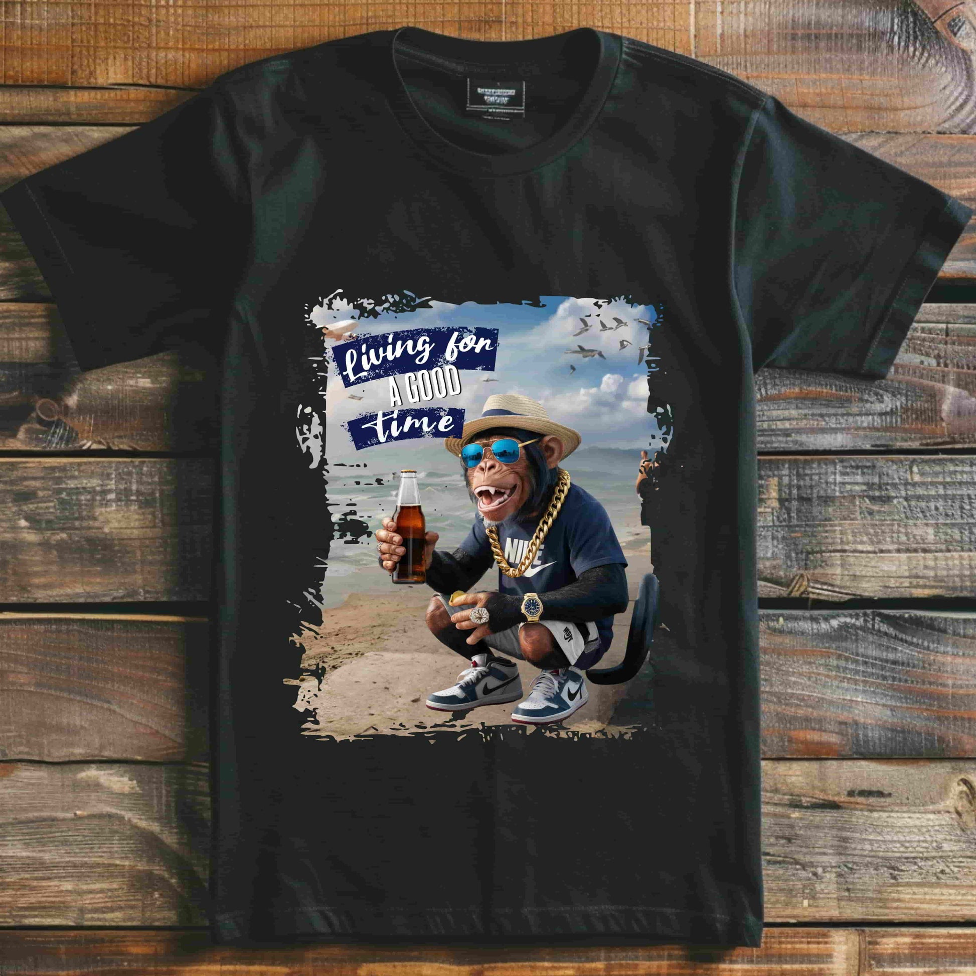 Humorous photo manipulation of a chimp on the beach dressed in hip-hop style with gold chains and sneakers, holding a bottle and money, with the slogan ‘Living for A GOOD TIME’. this image is printed in t-shirts on those colors Aqua Athletic Heather Berry Black Dark Grey Heather Kelly Heather Team Purple Heather True Royal Navy White