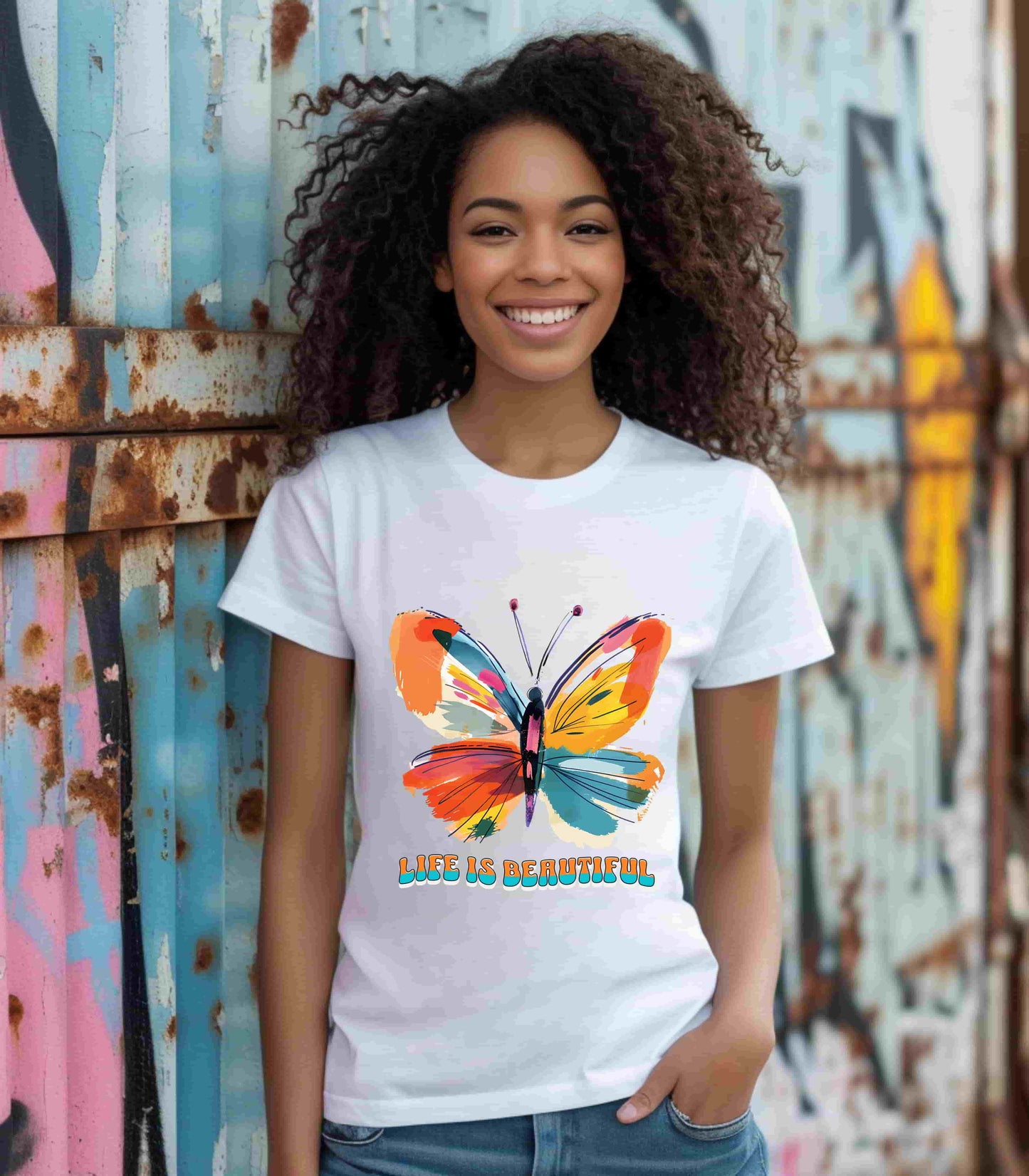 Colorful cartoon-style butterfly with vibrant wings and the text 'Life is Beautiful' designed for t-shirts in colors including Aqua, Athletic Heather, Berry, Black, Dark Grey Heather, Heather Red, Heather Team Purple, Heather True Royal, White, and Charity Pink