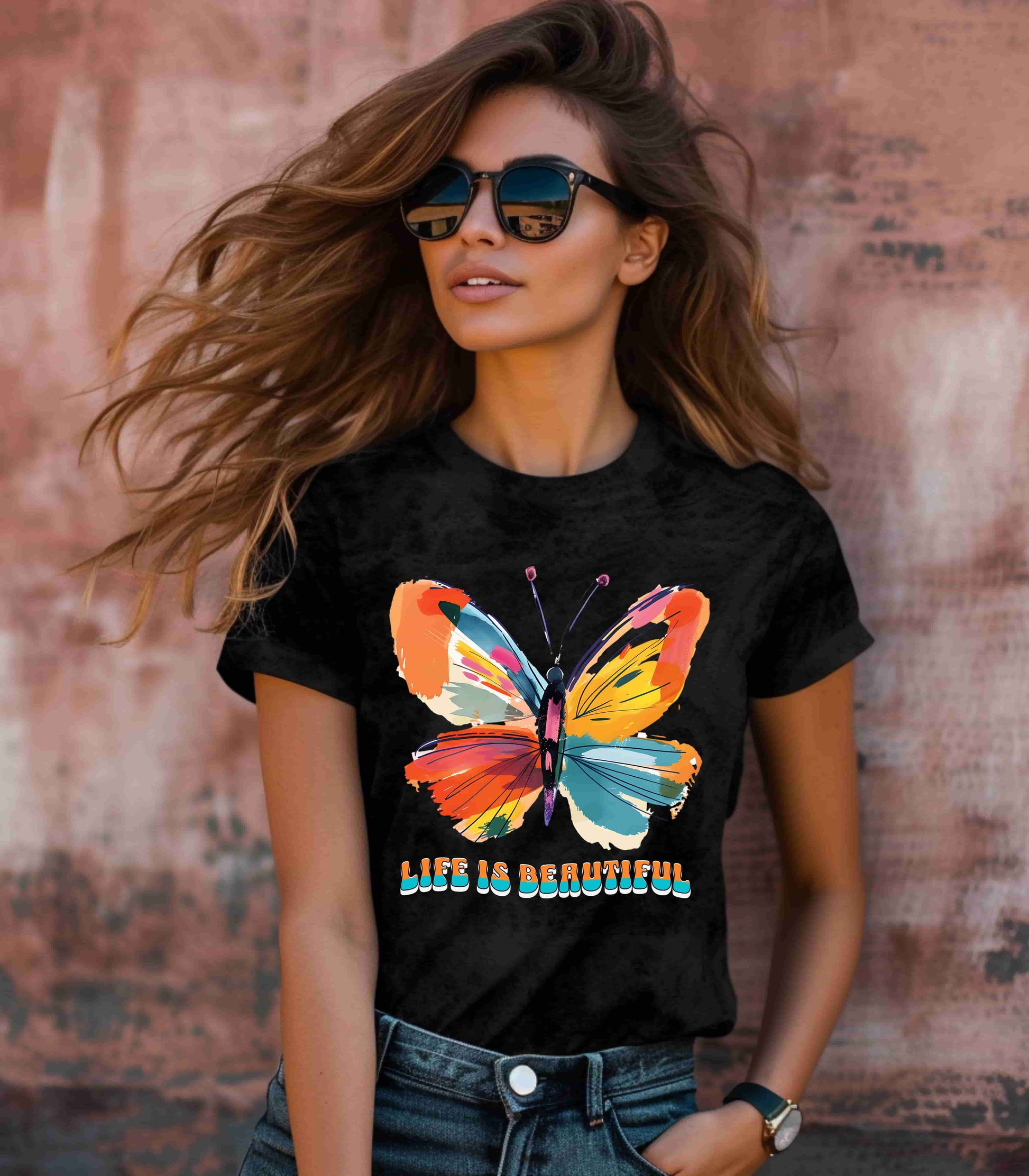 Colorful cartoon-style butterfly with vibrant wings and the text 'Life is Beautiful' designed for t-shirts in colors including Aqua, Athletic Heather, Berry, Black, Dark Grey Heather, Heather Red, Heather Team Purple, Heather True Royal, White, and Charity Pink