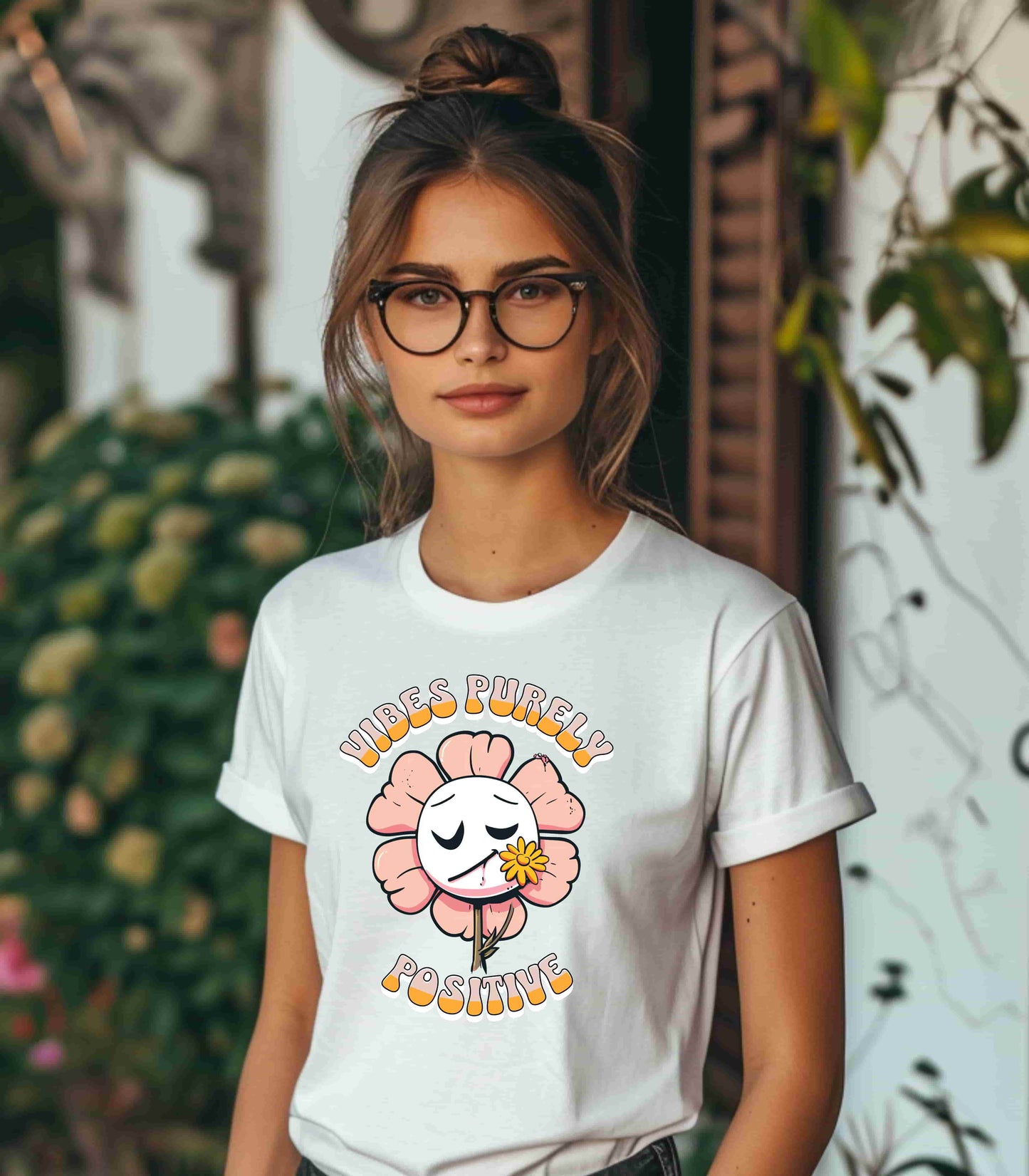 Cute pink flower with a smiling face and a yellow flower in its mouth, accompanied by the text "Vibes Purely Positive." This cheerful design is perfect for t-shirts available in colors Aqua, Berry, Black, Dark Gray, Heather Kelly, Heather Team Purple, Heather True Royal, Navy, White, and Charity Pink.